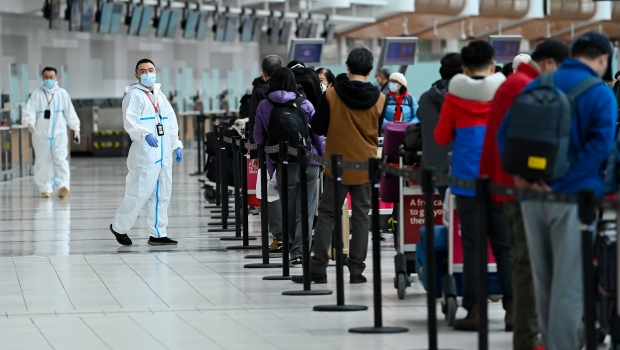 People line up and check in for an international flight at Pearson International airport during the COVID-19 pandemic in Toronto on Wednesday, Oct. 14, 2020. THE CANADIAN PRESS/Nathan Denette