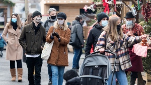 People wear face masks as they shop at a Christmas market in Montreal, Saturday, November 28, 2020, as the COVID-19 pandemic continues in Canada and around the world. (THE CANADIAN PRESS/Graham Hughes)