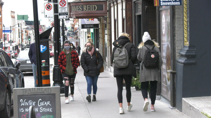 Kingston residents walk down the street wearing masks during the COVID-19 pandemic. (Kimberley Johnson / CTV News Ottawa)