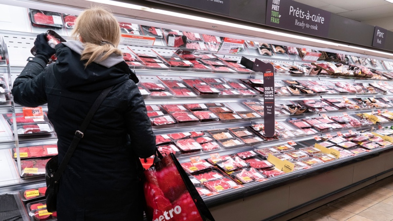 A customer shops at a meat counter in a grocery store in Montreal, on Thursday, April 30, 2020. THE CANADIAN PRESS/Paul Chiasson