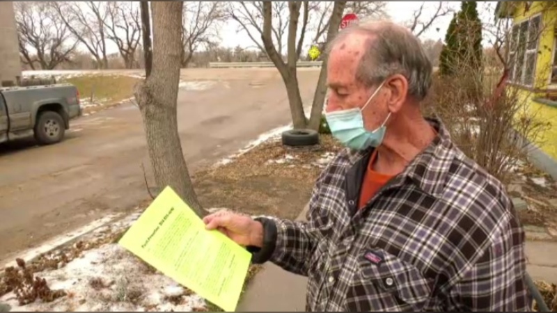 Sel Burrows created flyers filled with pandemic-related information and is handing them out in Point Douglas.