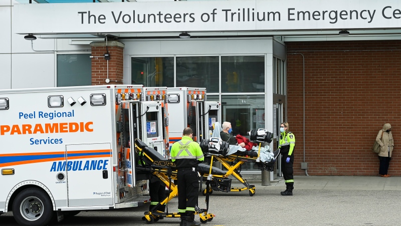 Paramedics transport an elderly man to the hospitals emergency department during the COVID-19 pandemic in Mississauga, Ont., on Thursday, November 19, 2020. (Nathan Denette/The Canadian Press) 
