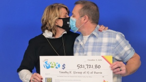 Denise Leclair and Timothy Klementti, of Barrie, celebrate their Lotto Max win at the Toronto Prize Centre. (OLG)