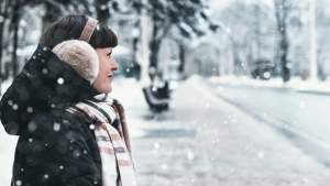 A woman walking through the snow is seen in this file image. (Pexels) 
