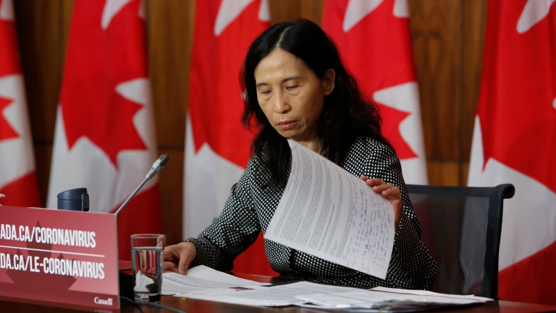 Chief Public Health Officer Dr. Theresa Tam organizes her notes during a press conference in Ottawa on Friday, Dec. 11, 2020. THE CANADIAN PRESS/David Kawai