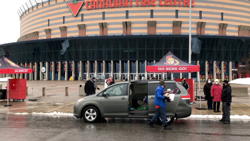 People drop off toy and non-perishable food donations at Canadian Tire Centre on Saturday. (Dave Charbonneau/CTV News Ottawa)