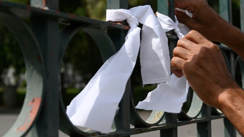 White ribbons on a cemetery fence in Colombo