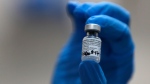 A nurse holds a vial of the Pfizer-BioNTech COVID-19 vaccine at Guy's Hospital in London, on Dec. 8, 2020. (Frank Augstein / AP)