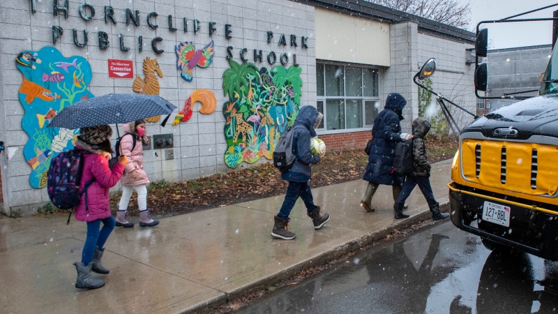Students from another school board a bus outside Thorncliffe Park Public School in Toronto on Friday December 4, 2020. THE CANADIAN PRESS/Frank Gunn
