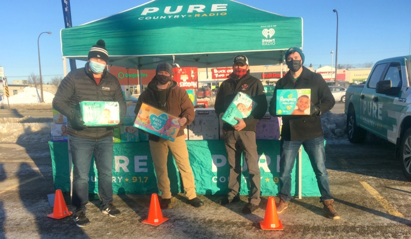 Pictured are Pure Country's Coop (left), Chris Earl of the Singing Soldiers, Justin Seguin of the Firehouse Bar & Grill and Pure Country's Josh. The goal of the campaign was to collect 100 boxes of diapers to help Sudbury's Pregnancy Care Centre and Infant Food Bank. The radio station actually quadrupled that goal, collecting more than 400 boxes of diapers and other goods. (Alana Everson/CTV News)
