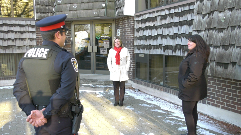 Greg Francis of the Brockville police (left) speaks with Lorena Crosbie (centre) from Children's Mental Health of Leeds and Grenville, and Sue Poldervaart (right), outside their offices on Chelsea Crt. in Brockville. (Nate Vandermeer / CTV News Ottawa)