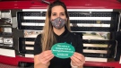 Christine Rozon, the sister of the late Cindy Devine, holds a sticker promoting fire extinguishers in vehicles, while also pushing for legislative and legal changes, in her Devine’s name. (Sean Irvine / CTV News)