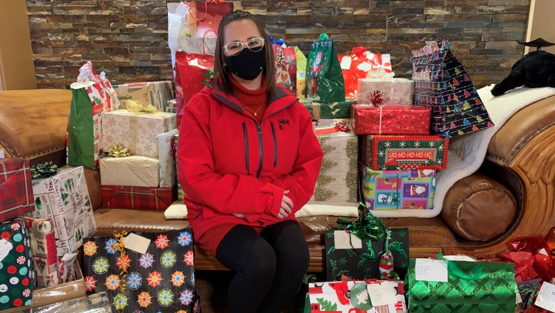 Christmas Spirit for Seniors Organizer Ashley Armstrong sits with the gifts the group has collected to give to Moose Jaw seniors in 2020. (Marc Smith/CTV News Regina)