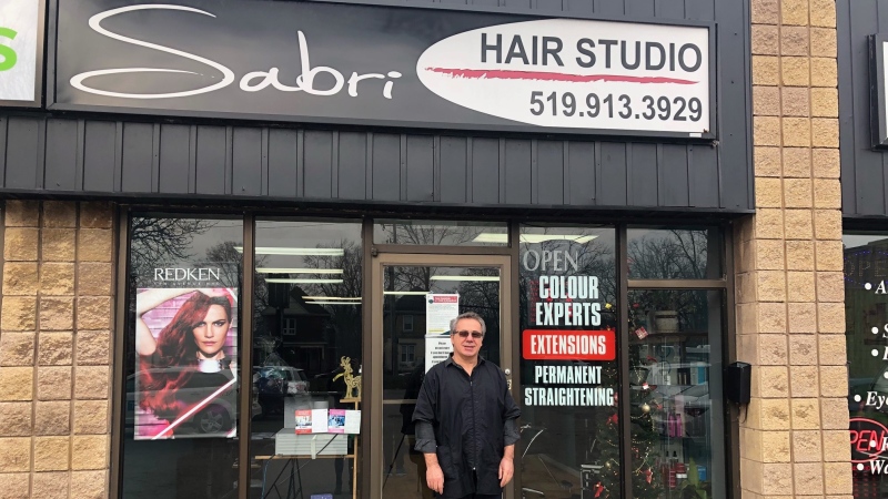 Sabri Sulejmani, owner of Sabri Hair Studio stands in front of open store in London, Ont. on Monday, Dec. 21, 2020, before it closes for 28 days during lockdown. (Jordyn Read / CTV News)
