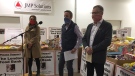 From left, Business Cares Food Drive Volunteer Coordinator Ally Hess, Business Cares Grocery Store Weekend Co-Captain Matt Trinnear and Wayne Dunn, chair of the Business Cares Food Drive, speak in London, Ont. on Tuesday, Dec. 22, 2020. (Bryan BIcknell / CTV News)