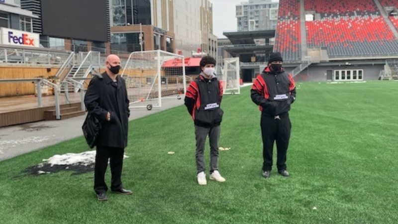 Ahmed Meradjah (centre) with best friend Abdul Al-hallak (right) and Ottawa Redblacks head coach Paul LaPolice (left). (Photo courtesy of Paul Howard)