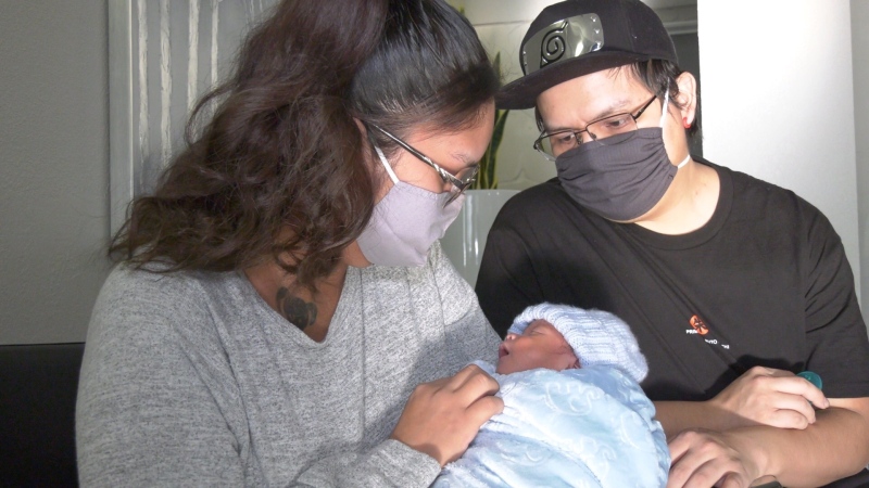 Esquimalt parents Tracy Louie and Kenny Charlie hold their son, Kenneth, who they claim was burned by a nurse at Victoria General Hospital: Dec. 22, 2020 (CTV News)
