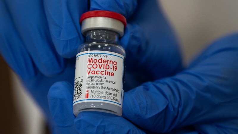 Michelle Chester, director of employee health services at Northwell Health, holds a bottle containing the Moderna COVID-19 vaccine at Northwell Health's Long Island Jewish Valley Stream hospital in Valley Stream, N.Y., on Monday, Dec. 21, 2020. (Eduardo Munoz/Pool via AP)
