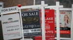 Real estate for sale signs are shown in Oakville, Ont. on Saturday, Dec.1, 2018. THE CANADIAN PRESS/Richard Buchan