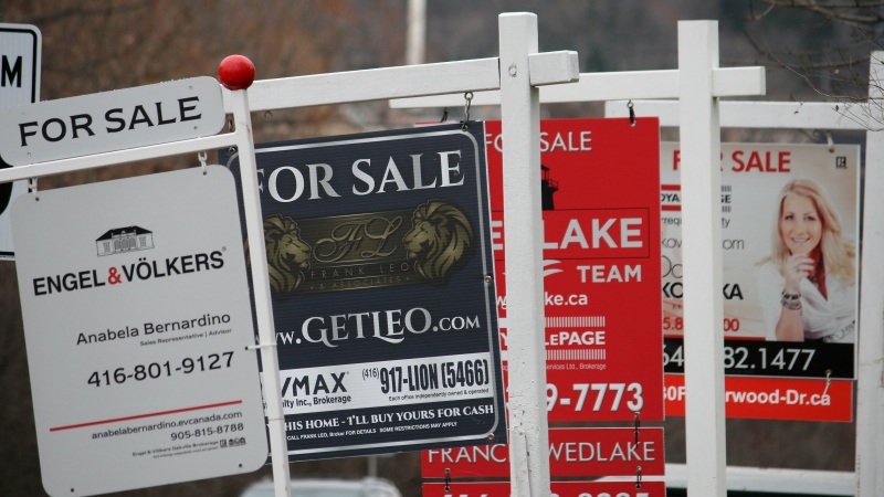 Real estate for sale signs are shown in Oakville, Ont. on Saturday, Dec.1, 2018. THE CANADIAN PRESS/Richard Buchan
