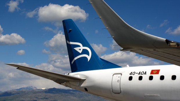 In this photo taken on April 10, 2014, Montenegro Airlines Embraer E195LR sits on the tarmac at the Golubovci airport, near Podgorica, Montenegro. (AP Photo/Risto Bozovic)