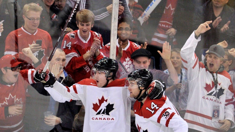 Canada forward Brett Connolly (14) celebrates his goal with Canada forward Boone Jenner (20) during first period IIHF World Junior Championships hockey action in Edmonton on Thursday, Dec. 29, 2011. THE CANADIAN PRESS/Nathan Denette