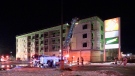 Firefighters work at the scene of a fire in a building under construction in London, Ont. on Monday, Dec. 28, 2020. (Jim Knight / CTV News)