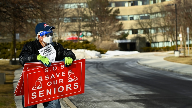 A man protests outside the Tendercare Living Centre long-term-care facility during the COVID-19 pandemic in Scarborough, Ont., on Tuesday, December 29, 2020. This LTC home has been hit hard by the coronavirus during the second wave. THE CANADIAN PRESS/Nathan Denette
