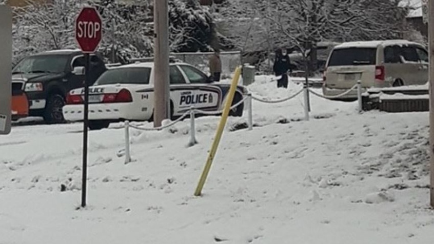 London police officer helps resident shovel snow