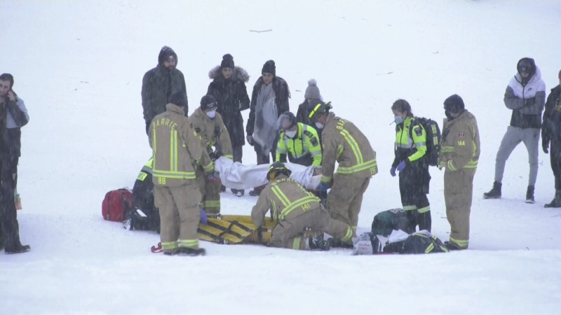Paramedics and firefighters help a patient at Sunnidale Park in Barrie, Ont. on Sunday, January 3, 2021 (Steve Mansbridge/CTV News)