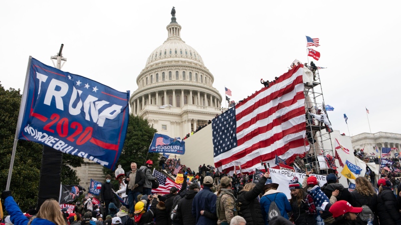 Supporters of President Donald Trump stand outside the U.S. Capitol on Wednesday, Jan. 6, 2021, in Washington. (AP Photo/Jose Luis Magana)
