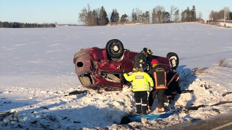 Car flipped into a snowy ditch after crash