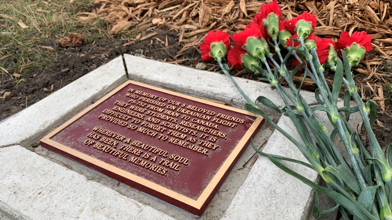 Fresh flowers sit atop a memorial to the five members of the UWindsor community killed on Jan. 8, 2020 when their plane crashed in Ukraine. The memorial is along the riverfront, near university campus. (Rich Garton/CTV News)