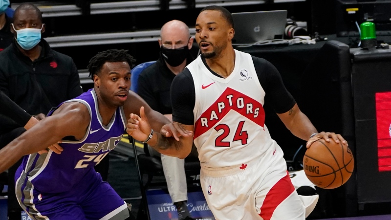 Toronto Raptors guard Norman Powelll, right, drives against Sacramento Kings guard Buddy Hield during the first quarter of an NBA basketball game in Sacramento, Calif., Friday, Jan. 8, 2021. The Raptors won 144-123. (AP Photo/Rich Pedroncelli)