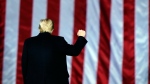 U.S. President Donald Trump gestures at a campaign rally in support of U.S. Senate candidates Sen. Kelly Loeffler, R-Ga., and David Perdue in Dalton, Ga., Monday, Jan. 4, 2021. (AP Photo/Brynn Anderson)