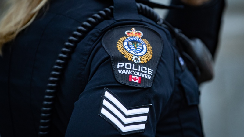 A Vancouver Police Department patch is seen on an officer's uniform as she makes a phone call after responding to an unknown incident in the Downtown Eastside of Vancouver, on Saturday, January 9, 2021. THE CANADIAN PRESS/Darryl Dyck