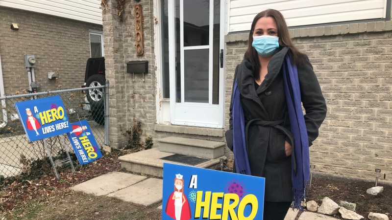 Dominique Gravel with a lawn sign from her "A HERO LIVES HERE" campaign in Windsor, Ont. on Monday, Jan. 11, 2020. (Alana Hadadean/CTV Windsor)