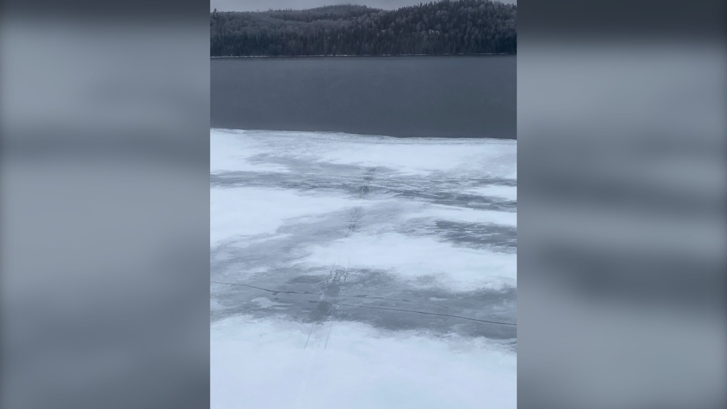 Snowmobile tracks on lake led to open water