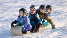 From left, Toby, 5, Caplan, 7, Mae, 8, and Claire, 8, toboggan at Mooney's Bay Park, in Ottawa on Christmas Day, Sunday, Dec. 25, 2016. THE CANADIAN PRESS/Justin Tang
