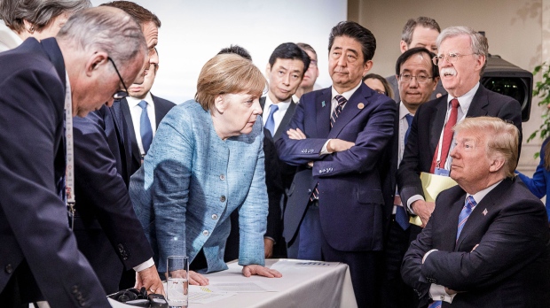 In this photo provided by the German Government Press Office (BPA), German Chancellor Angela Merkel deliberates with U.S. president Donald Trump on the sidelines of the official agenda on the second day of the G7 summit on June 9, 2018 in Charlevoix, Canada. (Photo by Jesco Denzel /Bundesregierung via Getty Images)
