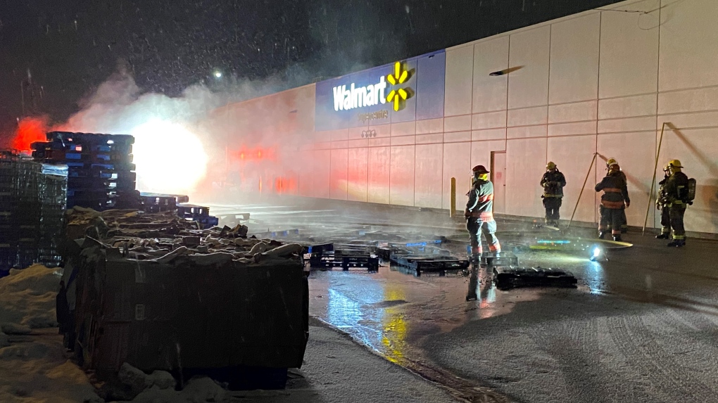 Firefighters behind a Walmart at night