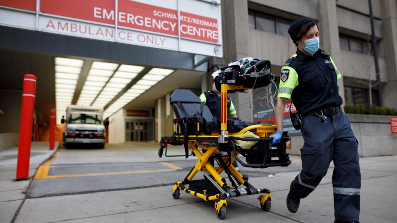 Paramedics wheel a gurney out from the emergency department at Mount Sinai Hospital in Toronto, Wednesday, Jan. 13, 2021. THE CANADIAN PRESS/Cole Burston
