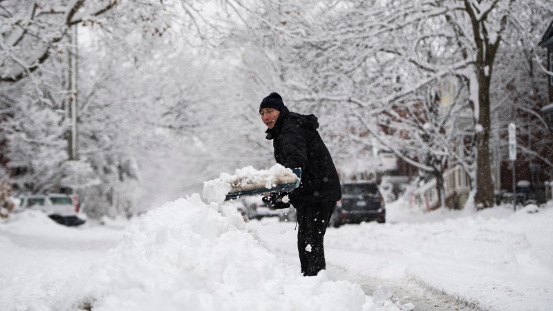 Benoit Leduc shovels his driveway during a major snowstorm in Ottawa on Saturday, Jan. 16, 2021.  (Justin Tang/THE CANADIAN PRESS)