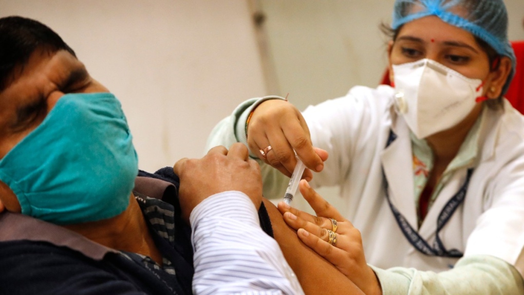 Administering a COVID-19 vaccine in New Delhi