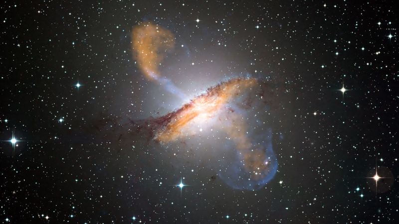 This composite image shows the Centaurus A galaxy in visible, microwave (orange) and X-ray (blue) light. Long jets expand out from the galaxy's central black hole on either side. (NASA/Royal Astronomical Society via CNN)