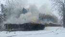 A motel near Stratford seen smoking as crews battle a fire. (@OPP_WR / Twitter)
