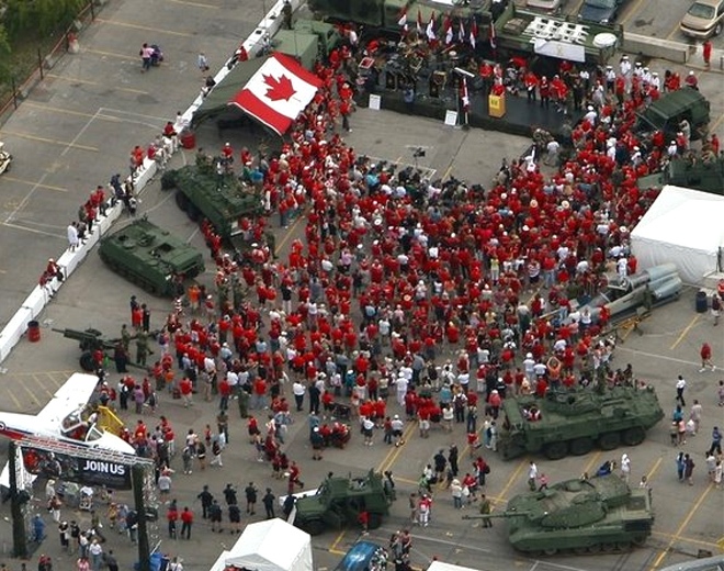 Hundreds gather while wearing red to show support for the troops in Afghanistan at a Toronto rally on Aug. 24, 2007.