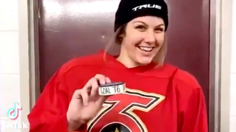 Lindsay Eastwood holding the puck from the goal she scored, the first in Toronto Six franchise history. (Lindsay Eastwood / TikTok)