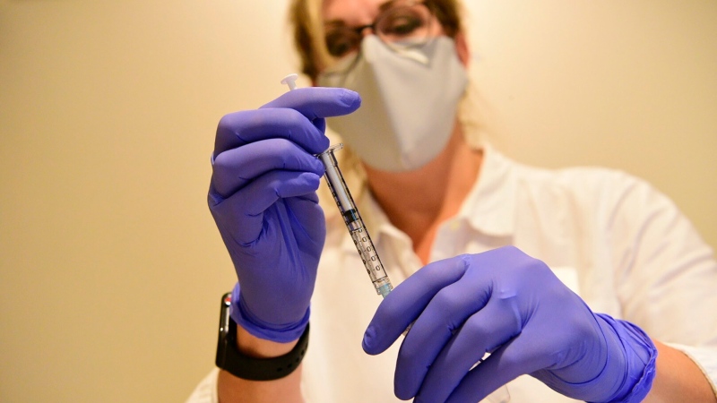 This Sept. 2020 photo provided by Johnson & Johnson shows a clinician preparing to administer investigational Janssen COVID-19 vaccine. (Johnson & Johnson via AP)