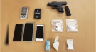 A loaded gun and drugs seized in London, Ont. on Thursday, Jan. 28, 2021 are seen in this image released by the London Police Service.